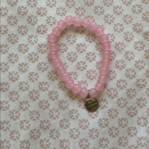 Pretty pink bracelet with silver charm